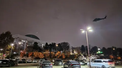 Reuters A helicopter flies around the National Assembly hall