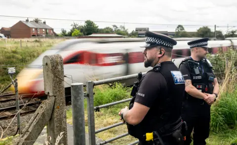 PA Media Police by a railway line