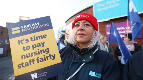 Liam McBurney/PA Wire Nurse Sarah Donnelly on the picket line outside the Royal Victoria Hospital in Belfast, as nurses in England, Wales and Northern Ireland take industrial action over pay. Picture date: Tuesday December 20, 2022.