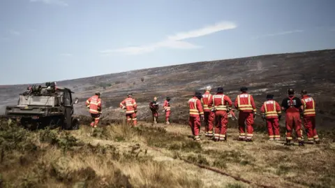 Derbyshire Fire and Rescue Service A number of firefighters on moorland