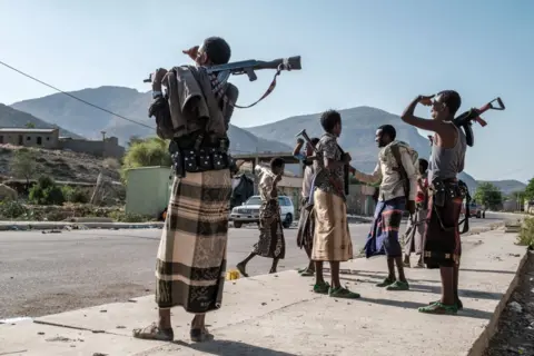 Armed members of a Ethiopian militia stand in a checkpoint 