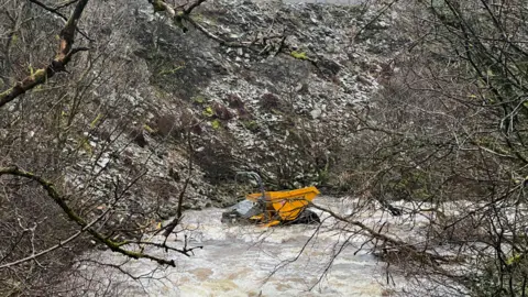 Dumper truck in river