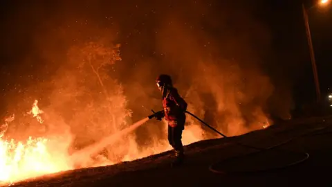 AFP A firefighter tries to extinguish a fire in Cabanoes near Louzan as wildfires continue to rage in Portugal on October 16, 2017