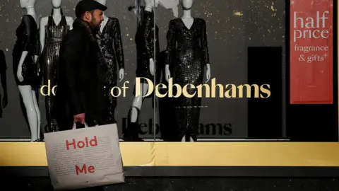 Reuters Man walking in front of Debenhams window