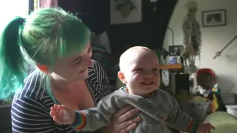 BBC Natalie Brown holding her baby