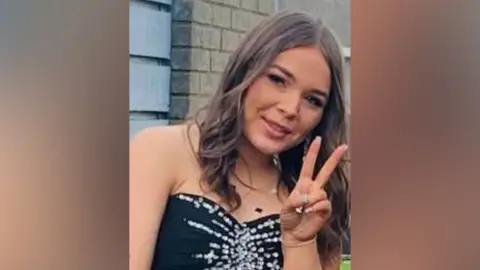 Jaidyn Rice has long brown hair and brown eyes and is smiling at the camera