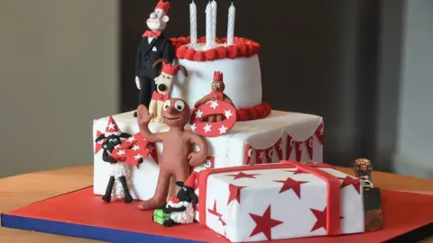 A cake with figures of Wallace and Gromit, Shaun the Sheep and Morph for Aardman Animations' 40th birthday in 2016