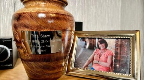 Image showing a picture of Rita next to an urn 