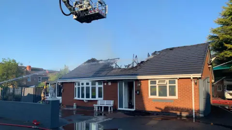 An image of a bungalow which was left with a damaged roof after a fire. 
