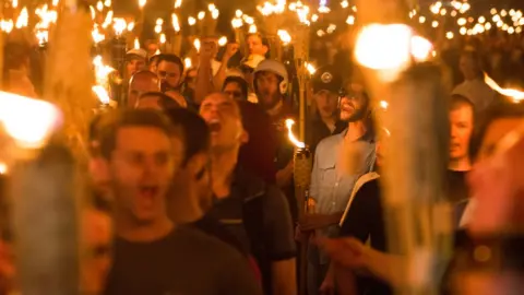 Getty Images White Supremacists take part in a Unite the Right rally in Charlottesville, Virginia, on 11 August 2017