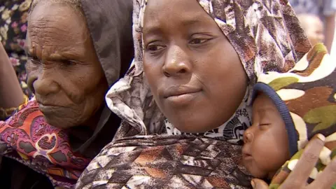 Displaced people queue for WFP handouts