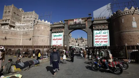 EPA Yemenis walk through Sanaa's Old City (20 January 2020)