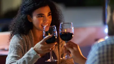 Getty Images Two people drinking wine