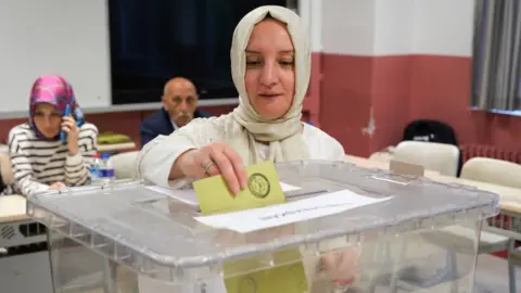 People casting their votes at a polling station