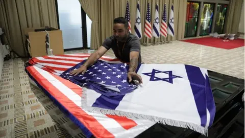 EPA Worker prepares Israeli and US flags in Israel (11/07/22)