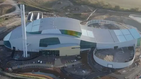 Viridor Ardley Energy Recovery Facility, which is a large, futuristic, silver building with a large chimney on the left hand side.