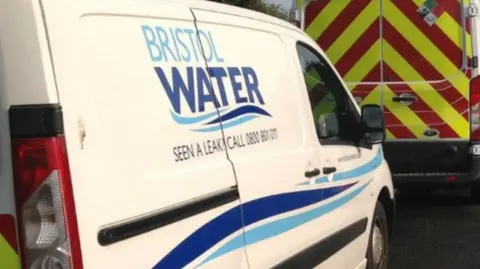 Bristol Water van that's white with sign parked in a car park. 