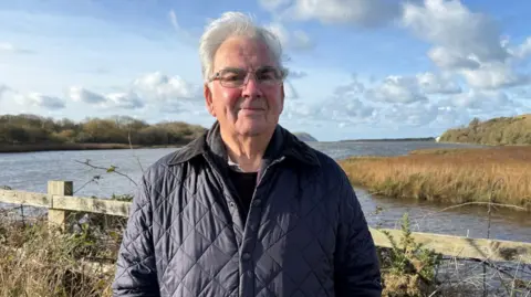 Don Evans was a detective chief inspector with Dyfed-Powys Police, and stands next to the estuary in Newport in Pembrokeshire, close to where they caught one gang member