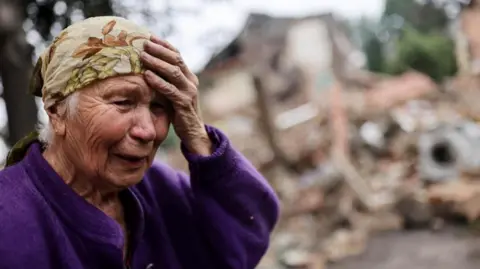 Reuters An elderly woman cries at the site of a missile strike in a Ukrainian town