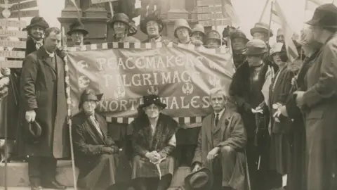 WCIA / Temple of Peace Archives black and white photo of women in 1923 holding a flag