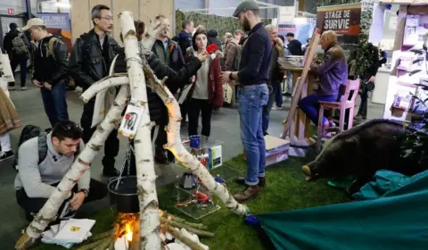 Getty Images People visit a survival training stand at the Survival Expo in Paris. 23 March, 2018.