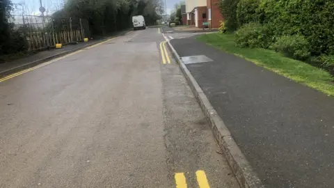 John Devine/BBC Locals are not sure if they can legally park in between the yellow lines