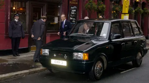 Getty Images Prince Philip and his taxi at opening of Cartoon Museum (2006)