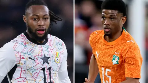 A split image shows two players from the waist up in action for their countries. On the left is Antoine Semenyo wearing a white Ghana shirt which features on its front an intricate spiderweb design in red, blue and yellow, as well as a black five-pointed star and a black number 11 on the chest. On the right is Amad Diallo in an orange Ivory Coast shirt with a white number 15 on the chest
