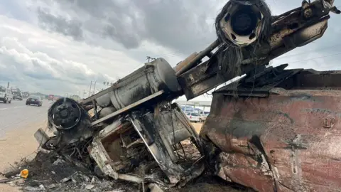 Andrew Gift / BBC An overturned and burnt-out tanker along a main road in Ibafo, Ogun state, Nigeria - Wednesday 16 October 2024