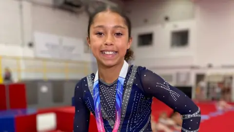 Tyliyah, looking at the camera, in her competition kit