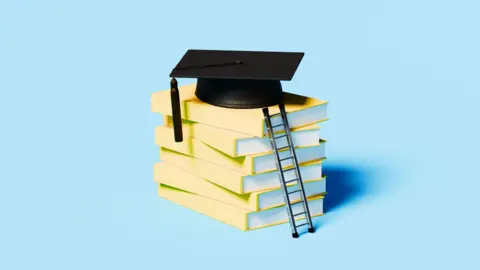 An image of a small ladder lent against a pile of yellow books bit a mortarboard on top