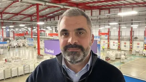 Tom Bailey, plant manager at Medway Mail Centre, standing on platform overlooking the mail floor