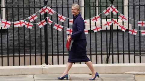 PA Media Home Secretary Yvette Cooper arrives at Downing Street in front of a row of English flags 