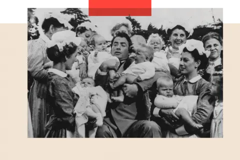 Getty Images Gregory Peck struggling to hold two babies, a a group of nurses present him, filming a scene for 'The Million Pound Note'