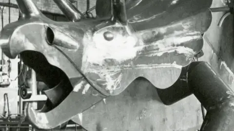 John Buchan Collection, Teesside Archives A steel triceratops sits in a warehouse ahead of being placed at the park