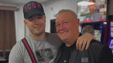 Family Kane Forder stands with his arm around his dad Dave. 