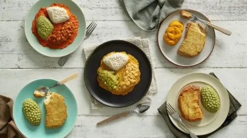 Five plates of pureed food, presented to look like the food in contain