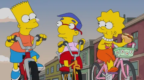 Fox/Alamy Bart Simpson, Milhouse and Lisa Simpson cycling, in a still from The Simpsons