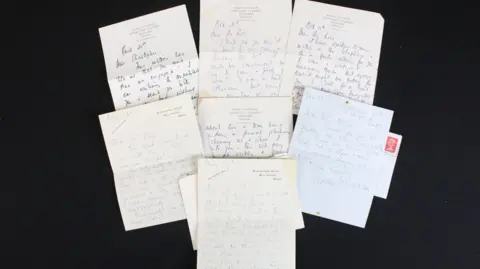 Wessex Auction Rooms A collection of six handwritten letters spread out on a black background.