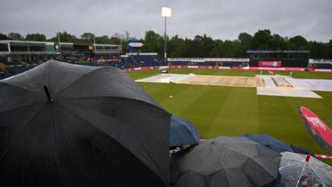 Sophia Gardens outfield with covers up and umbrellas in the crowd