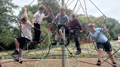 BBC primary school boys climbing on the spiders web frame 