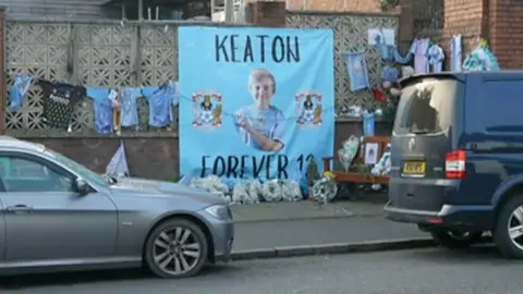 A sky blue banner reading Keaton Forever 12 at the scene of a fatal road crash