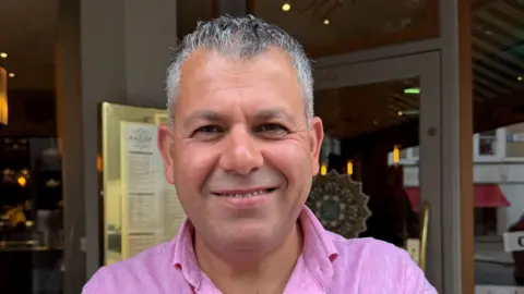 BBC/Jeevan Nerwan Iranian restaurant owner Dilman Mahmoud 