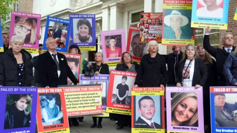 PA Bereaved families gathering outside Chelmsford Civic Centre on the opening day of the Lampard Inquiry