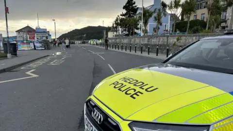 BBC A police car at the scene