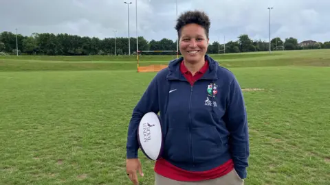 BBC Shaunagh Brown on the pitches at her home club Medway RFC in Rochester holding a Royal London rugby ball