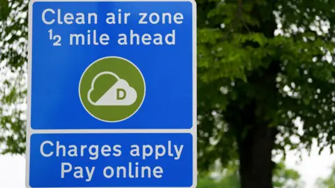 PA Media Signs in Birmingham City Center informing road users of the Clean Air Zone initiative.