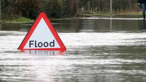 PA Media Flood sign and water on the road surface