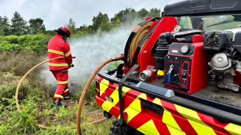 A firefighter demonstrating the Polaris off-road firefighting vehicle