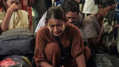 Getty Images Mourners react during a funeral for the victims of a bombardment carried out by Myanmar's military in Mrauk